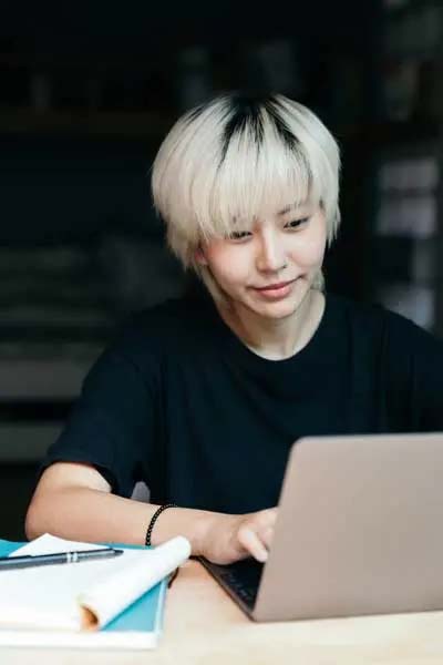 a student doing work on a laptop computer